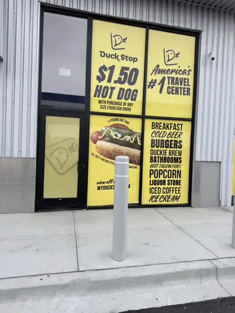 Window graphics for Duck Stop: storefront window promotions and hours. Installed by Sheridan Print in the Chicago area.