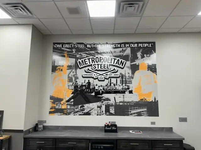 Wall mural for Metropolitan Steel: break room mural built around the company story. Installed by Sheridan Print in the Chicago area.