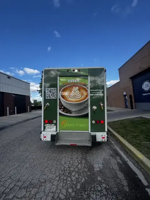 Box truck wrap for Yami Fresh: rear roll-up door with a coffee photo and qr code. Installed by Sheridan Print in the Chicago area.